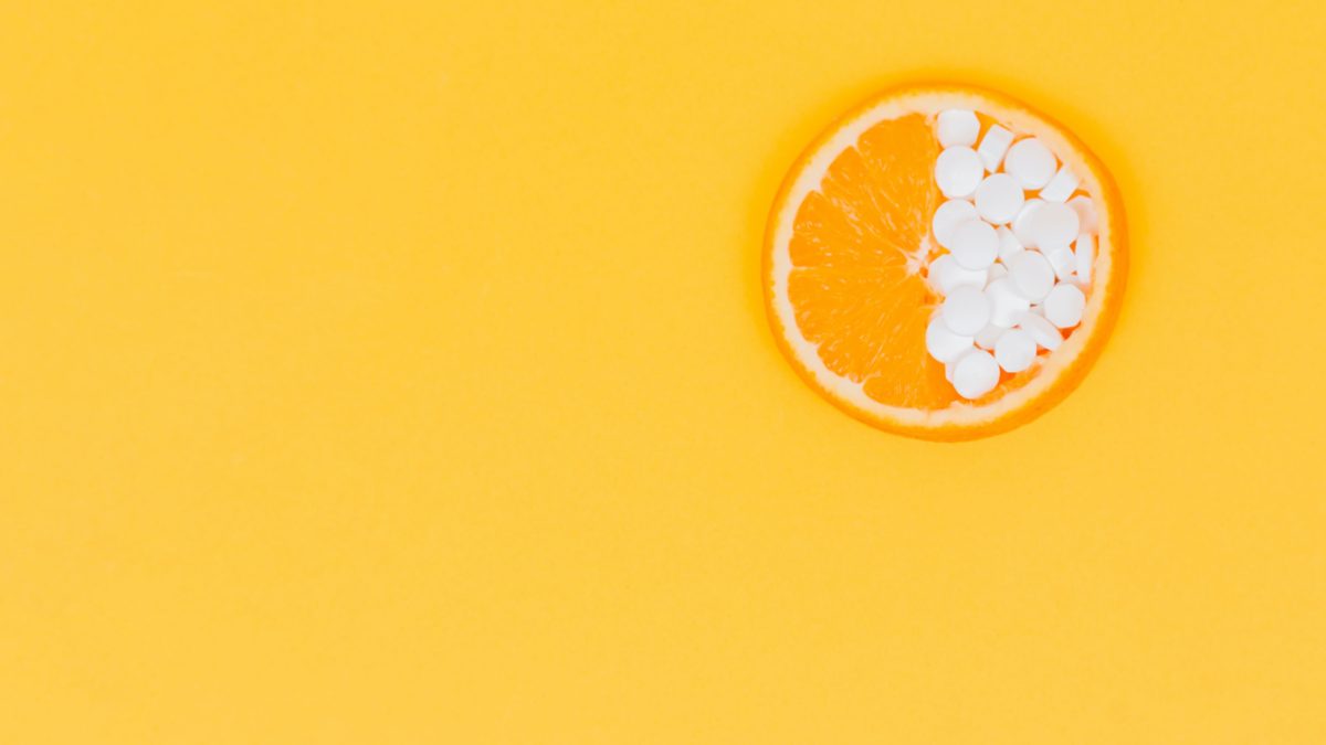 photo of orange halfway filled with pills for "therapy for the unhealthy gut" blog