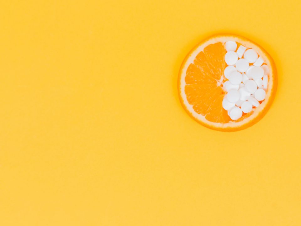 photo of orange halfway filled with pills for "therapy for the unhealthy gut" blog