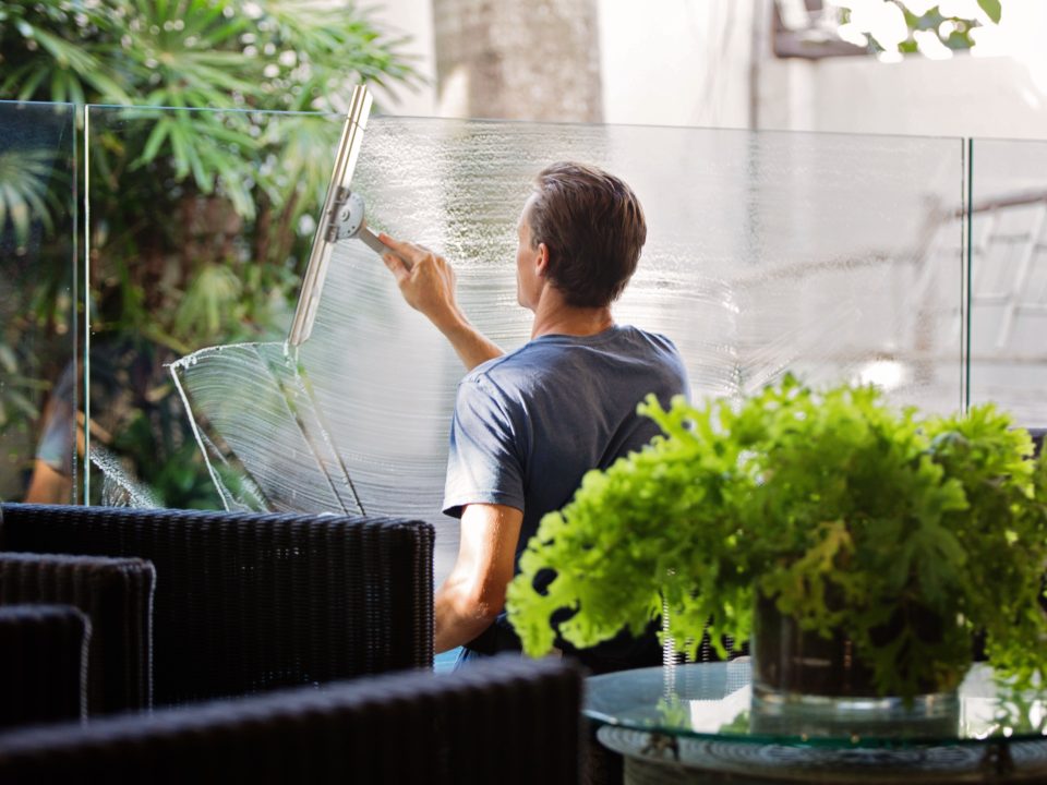 stock photo of man cleaning glass